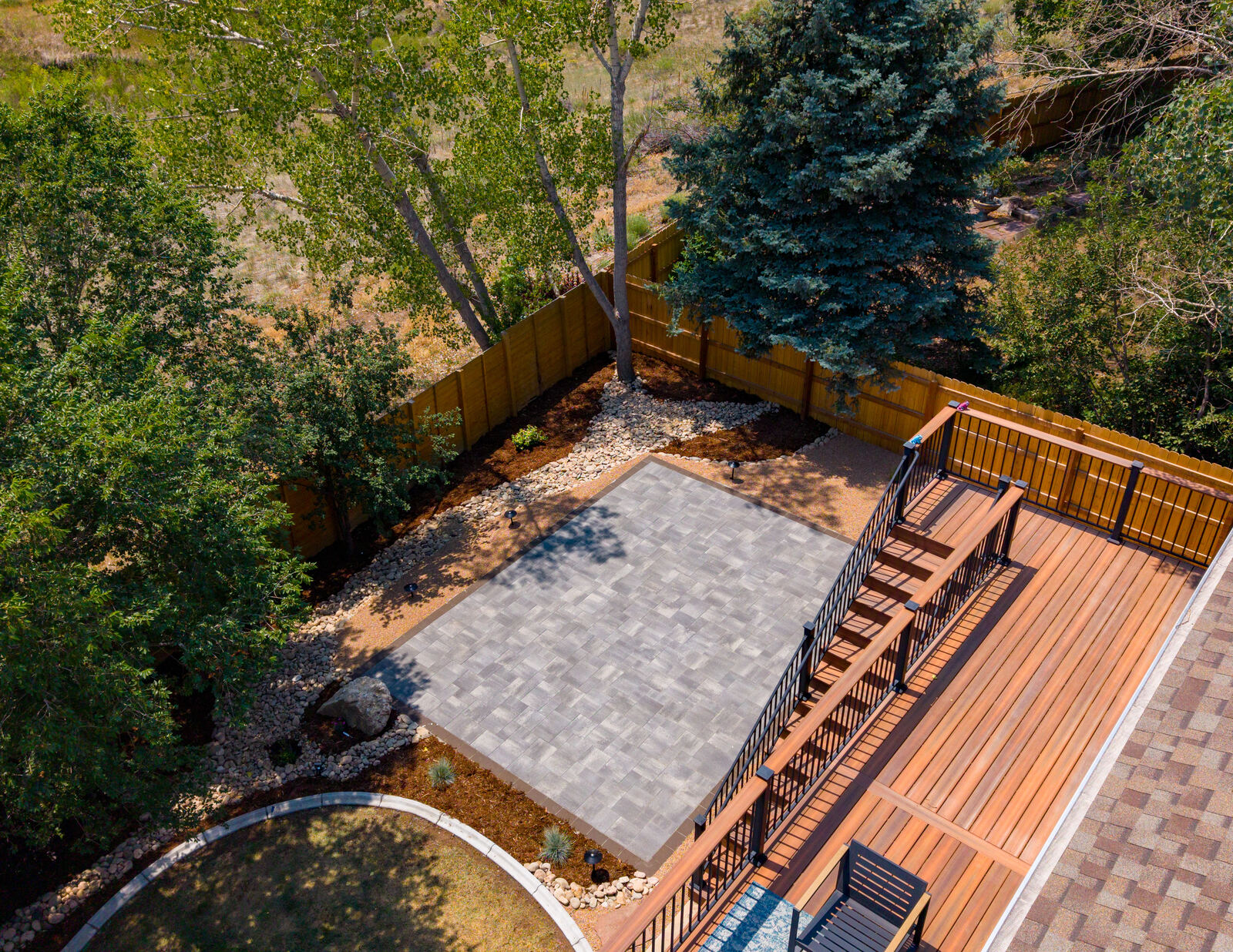Paver patio, deck and water feature from above