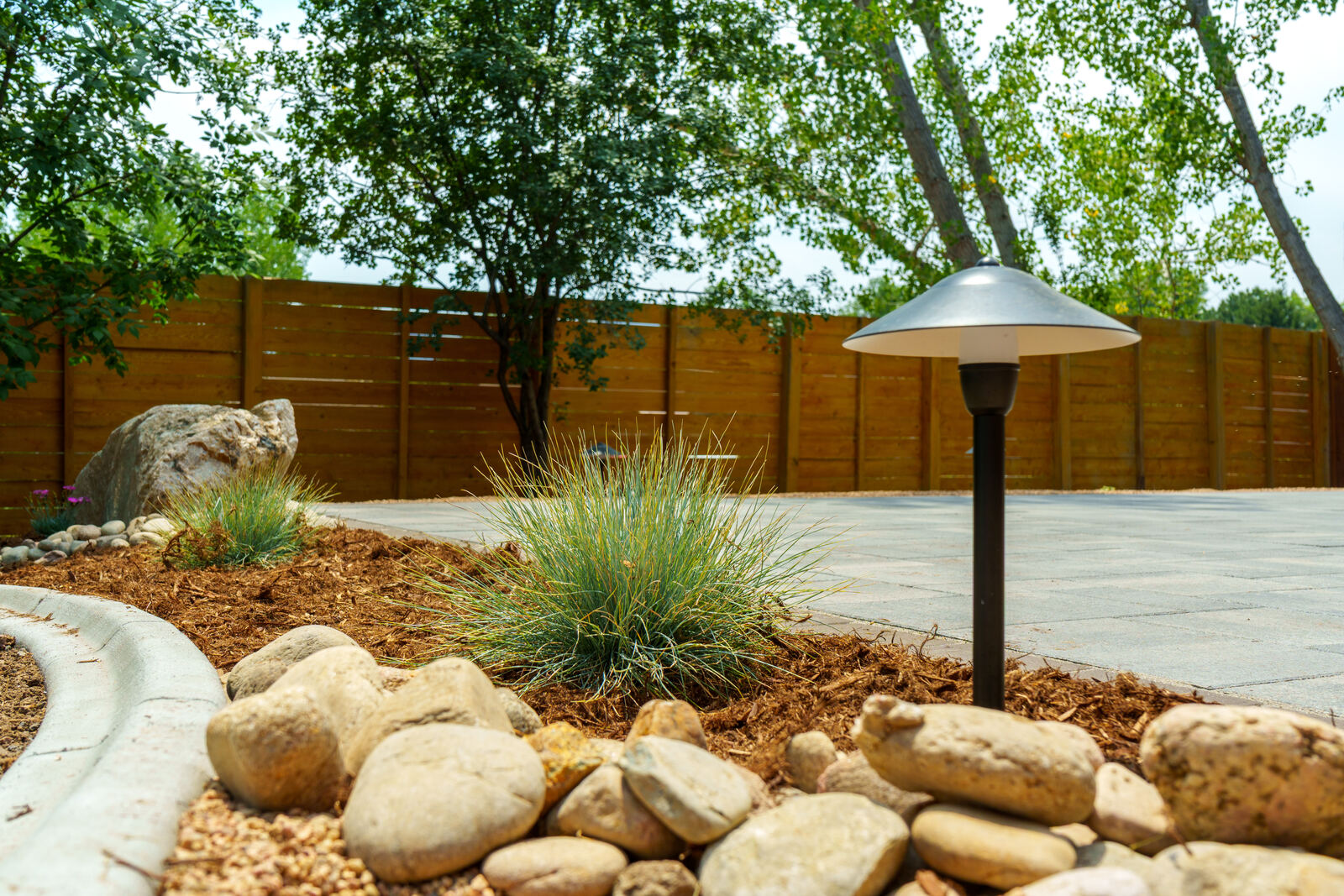 Boulder and rock planting bed with path lighting