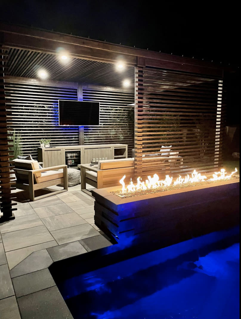 Outdoor fire feature and lounge at night
