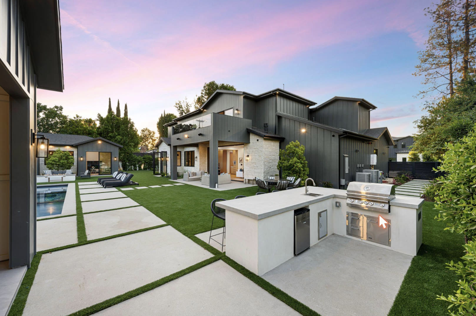 Backyard turf, pavers and outdoor kitchen