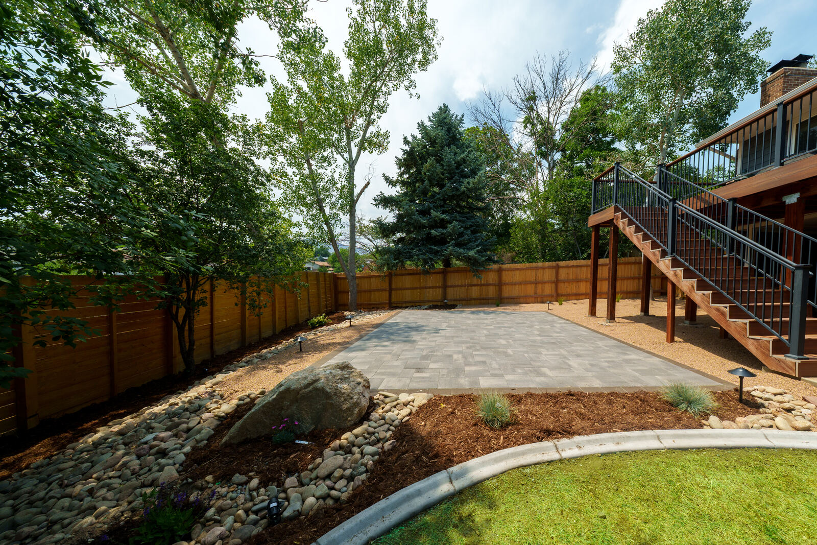 Paver patio, deck stairs and rock beds