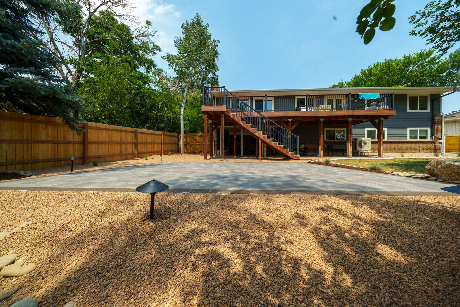 Low-water backyard with rock and deck